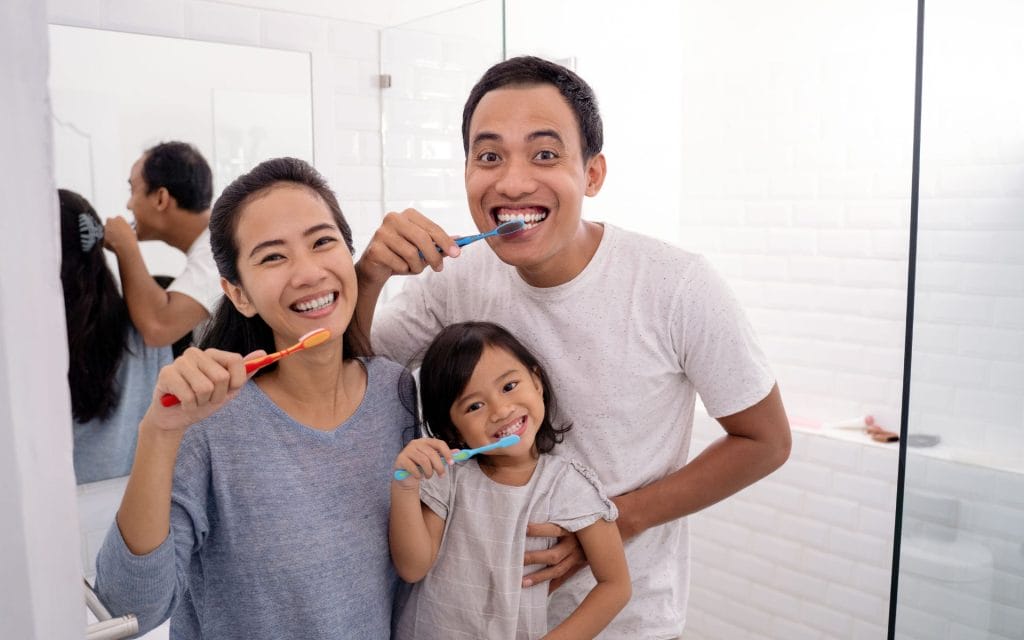 Family brushing after seeing a dentist in san antonio