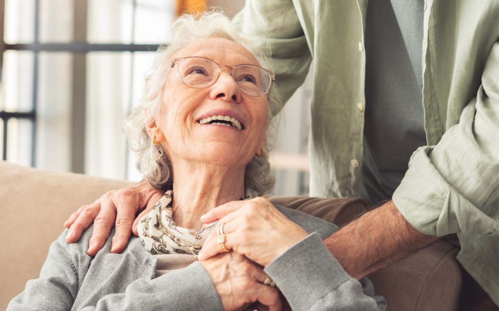 Dementia and Oral Health woman gazes up lovingly at her caregiver